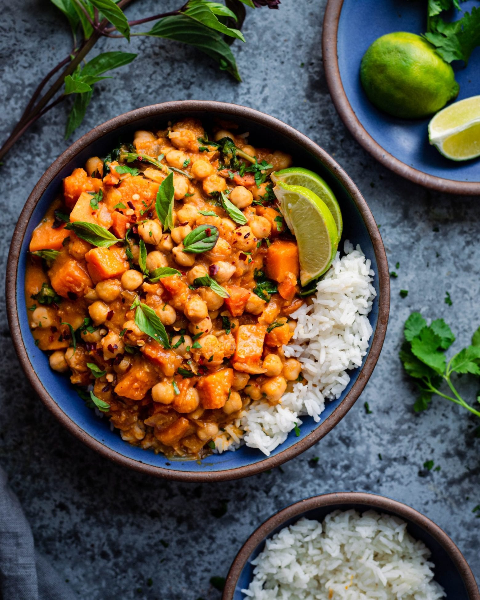 butternut squash chickpea curry with white rice and limes in bowl
