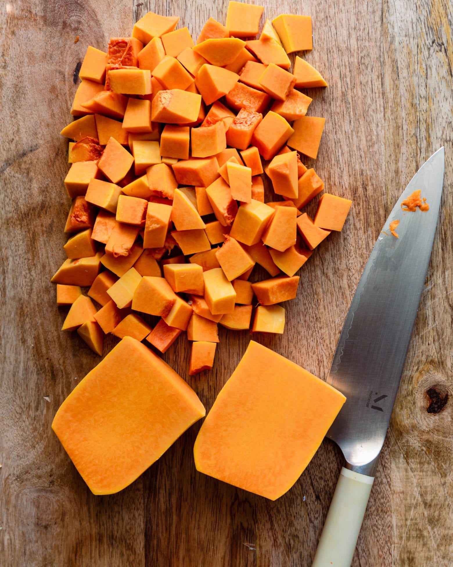 diced butternut squash with knife