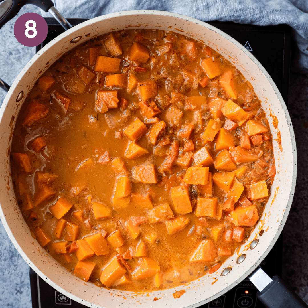 butternut squash curry with diced butternut squash in a saute pan.