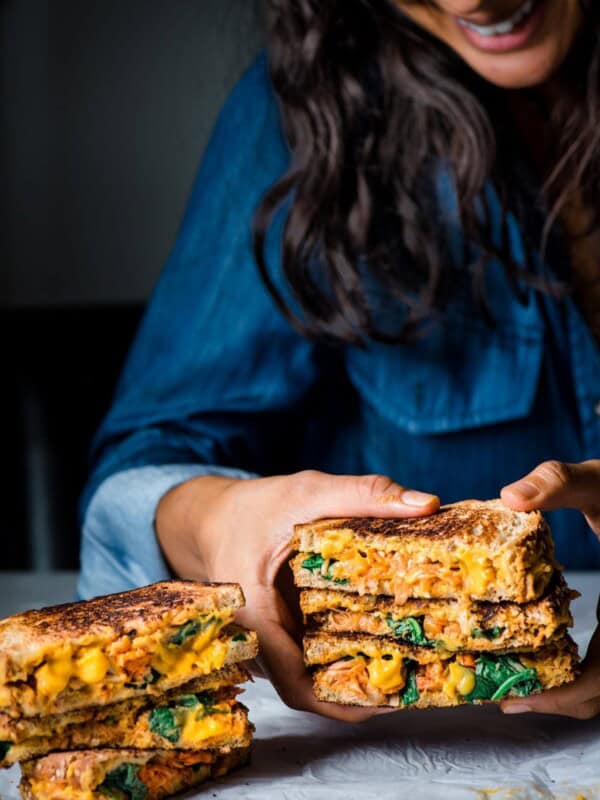 photo of woman holding vegan grilled cheese sandwich