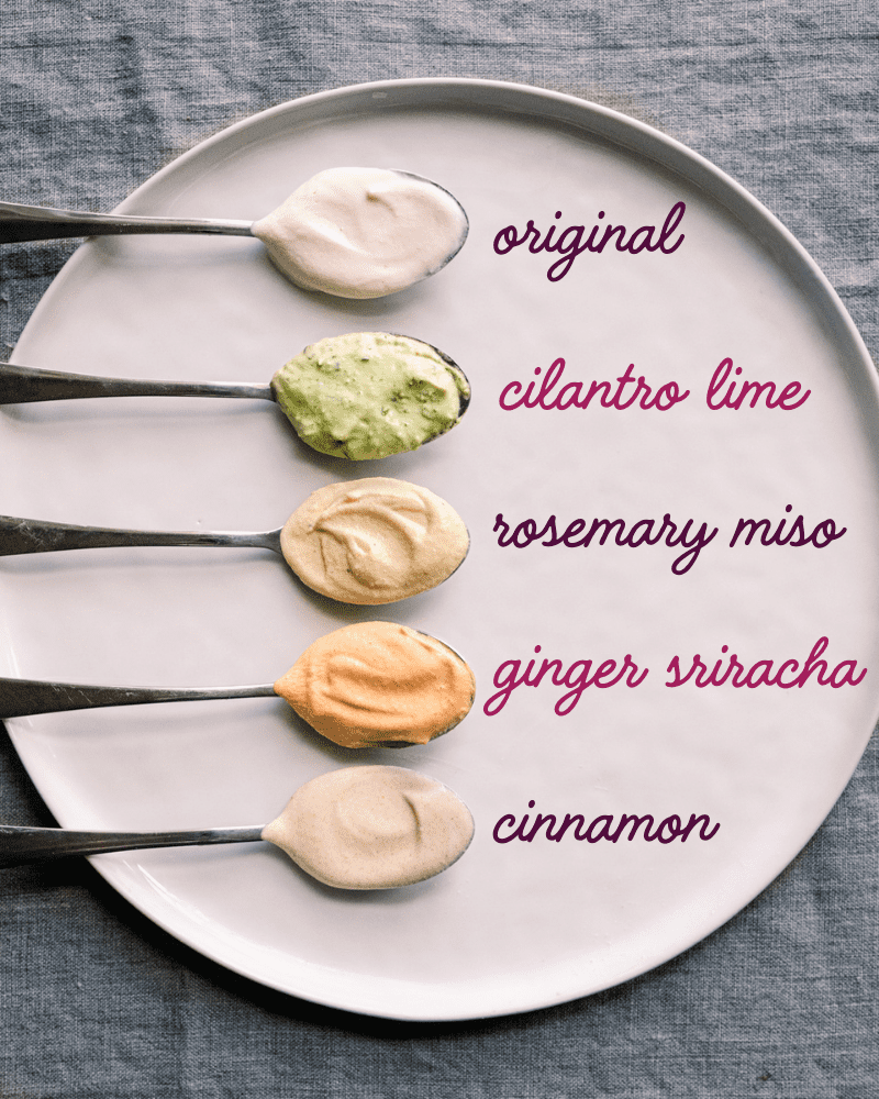 five flavor variations of cashew cream on spoons sitting on plate with labels