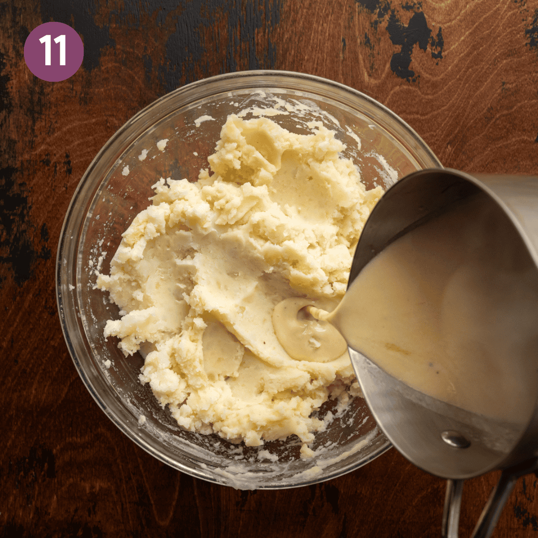 saucepan pouring melted butter-miso mixture into mashed potatoes in a glass bowl.