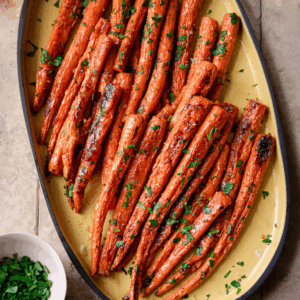 maple roasted carrots on a serving platter on a table.