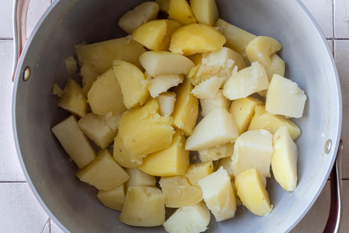 chopped cooked potatoes in saucepan