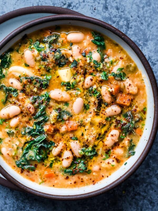 close up of creamy white bean soup with kale and gremolata in bowl