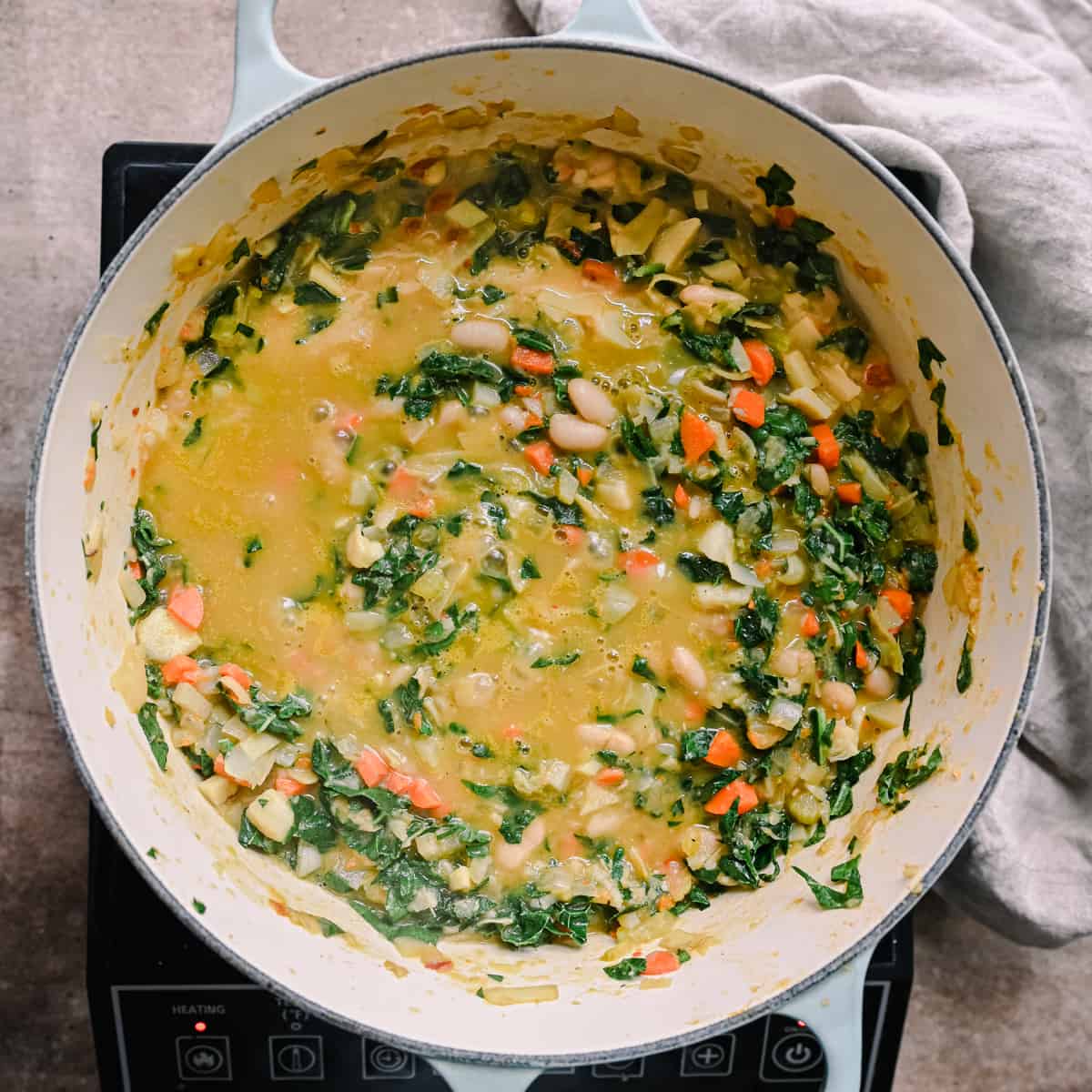 kale stirred into white bean soup