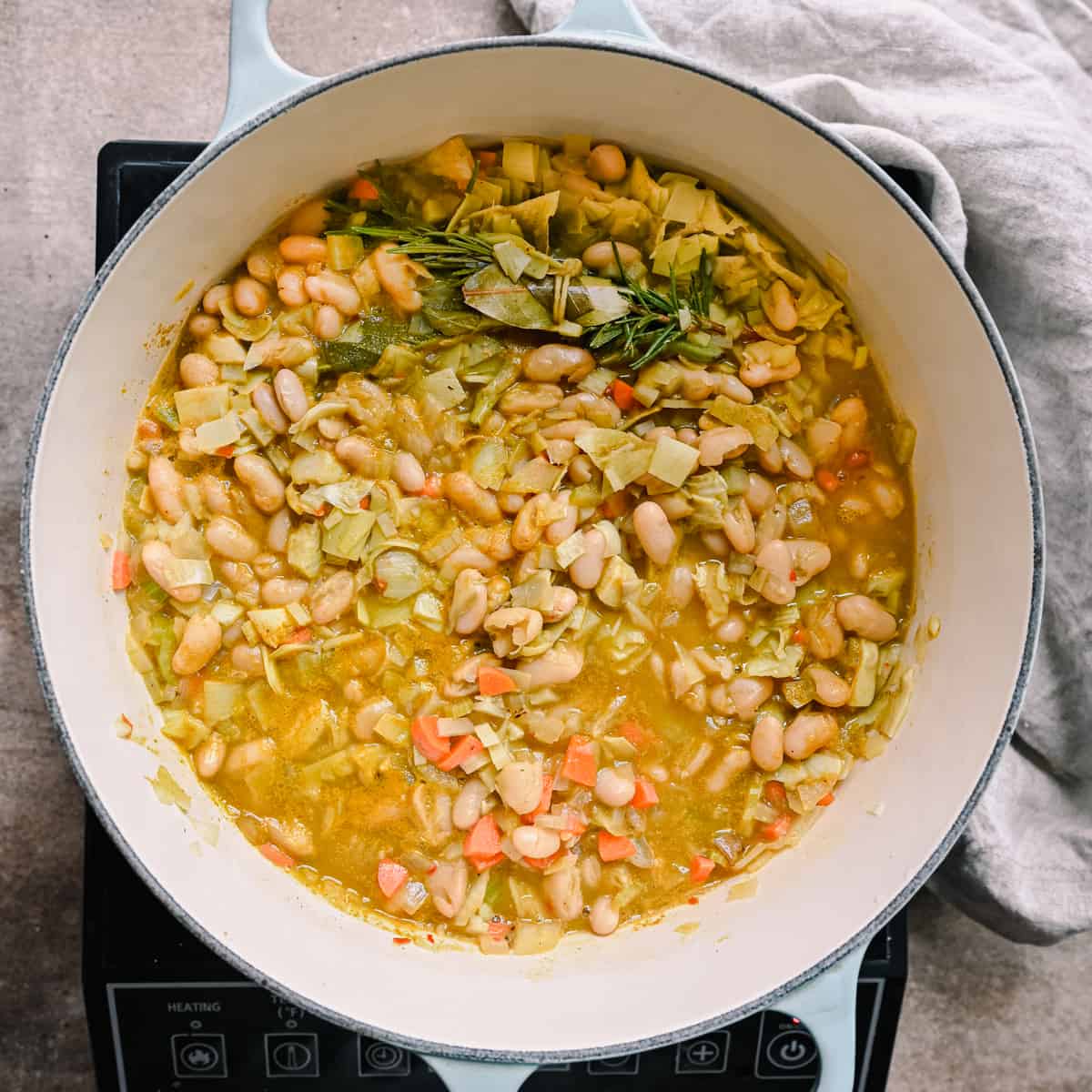 cooked white bean soup in a dutch oven