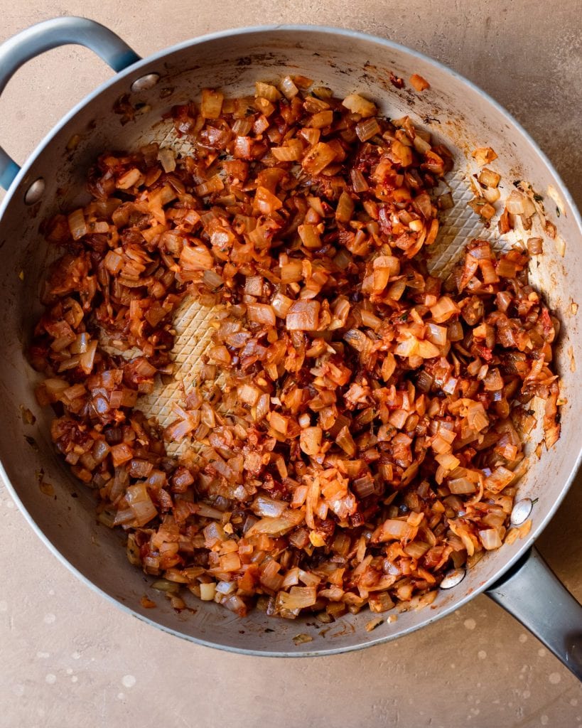 tomato paste stirred into onions in skillet