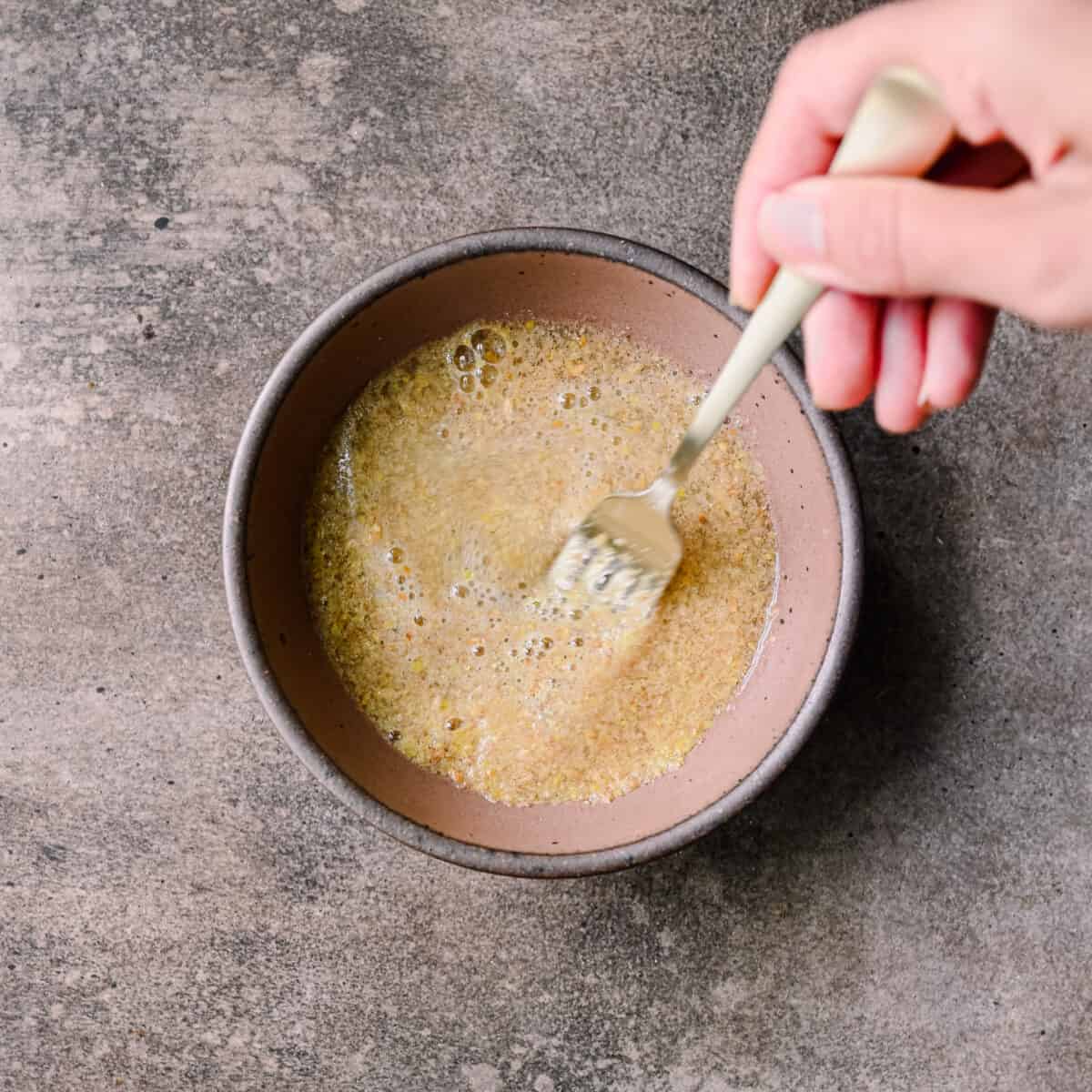 whisking flaxseed meal with water to make flax eggs