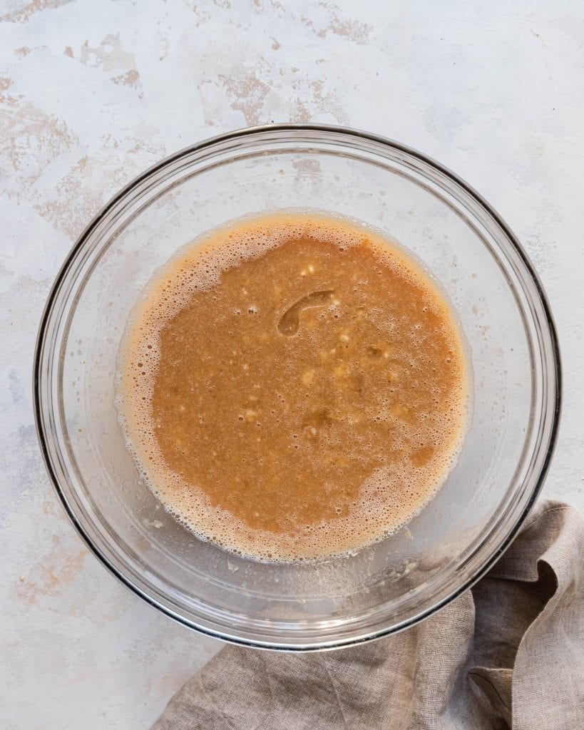 liquid ingredients mixed together in a bowl for banana bread