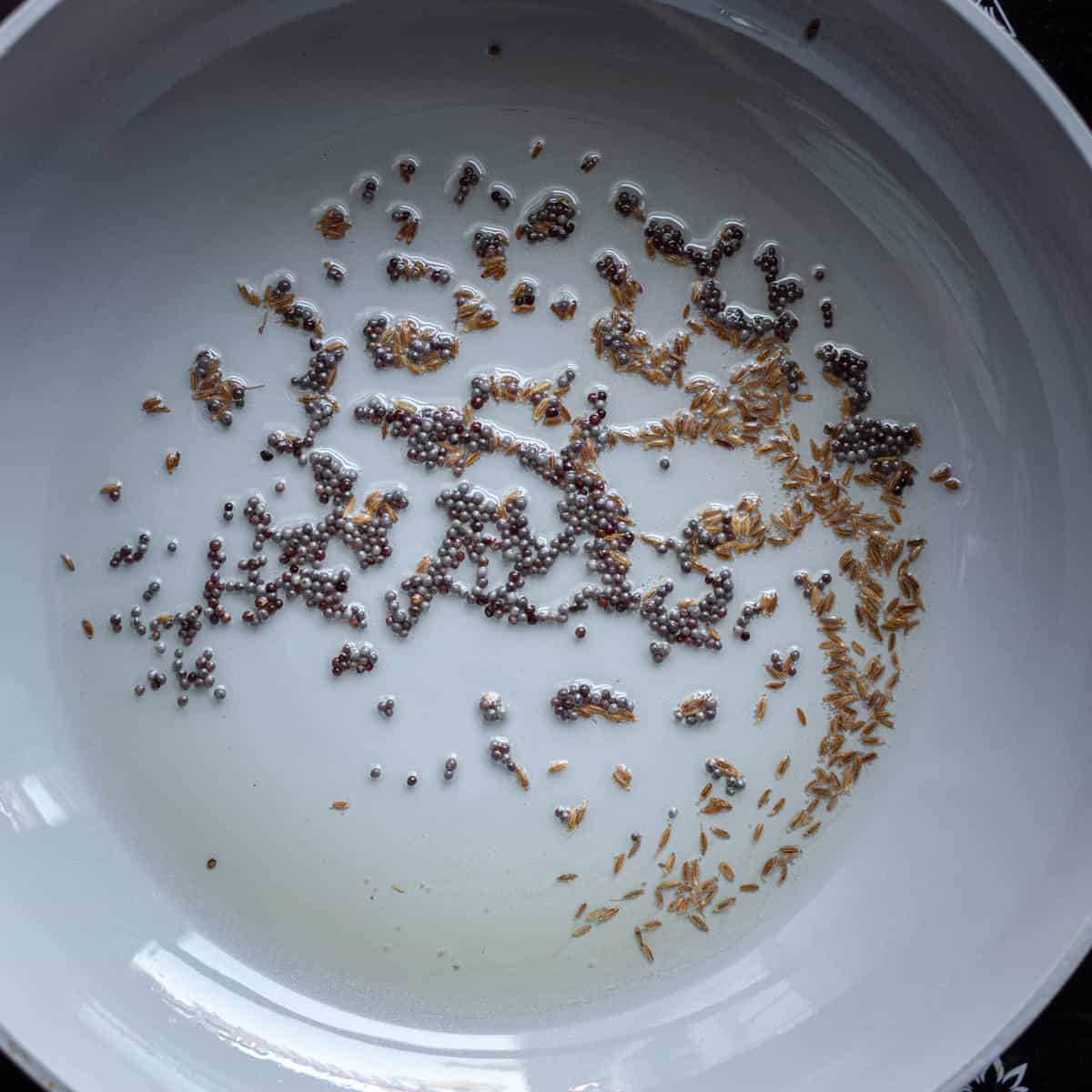 mustard seeds and cumin seeds in oil for tadka