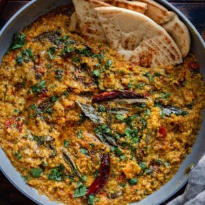 dal tadka in a pan with naan.