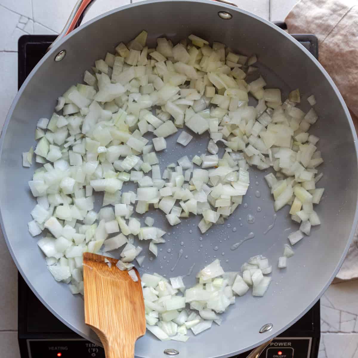 sauteing onions in a frying pan