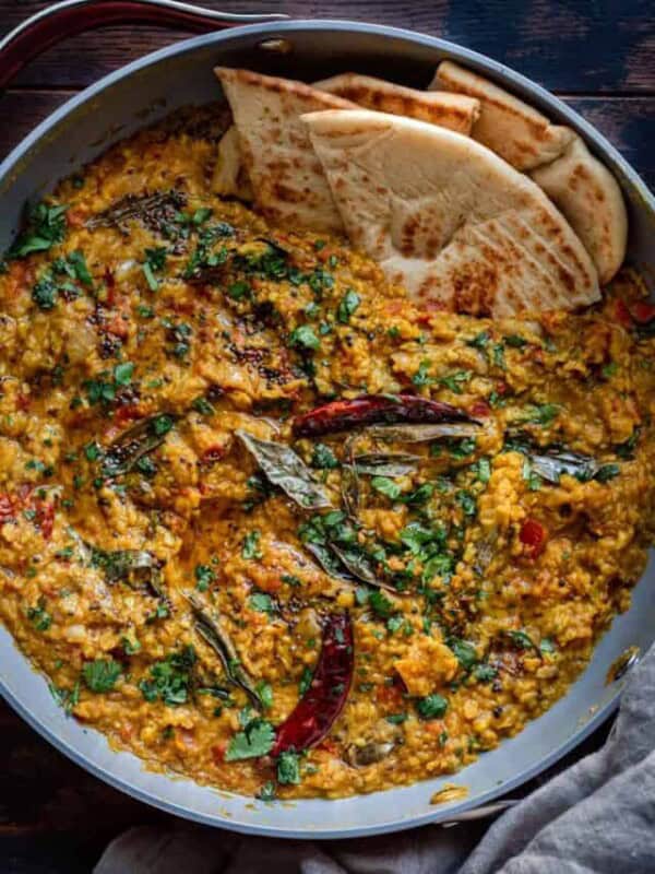 dal tadka in a pan with naan.