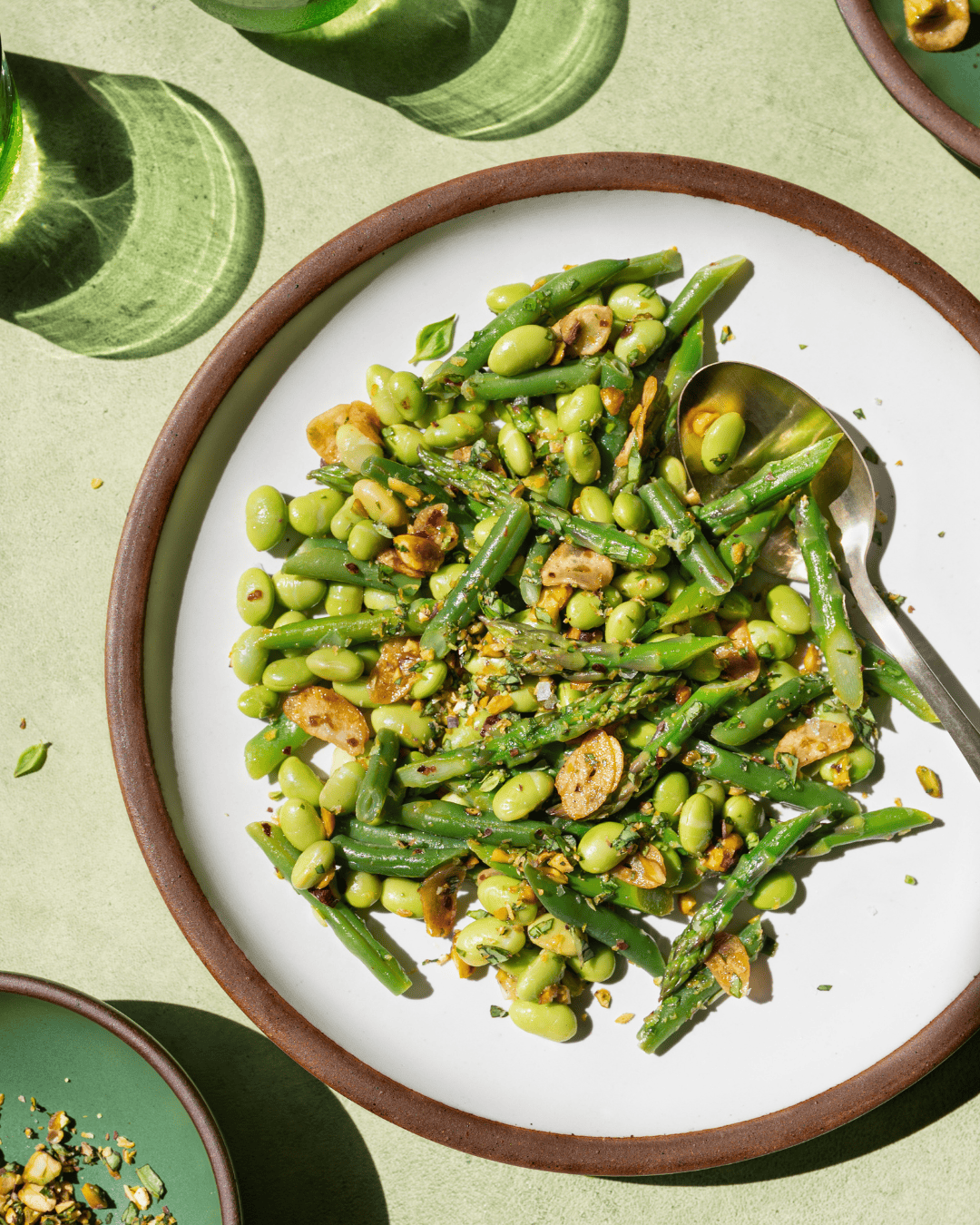 asparagus and green bean salad on a plate on a table.