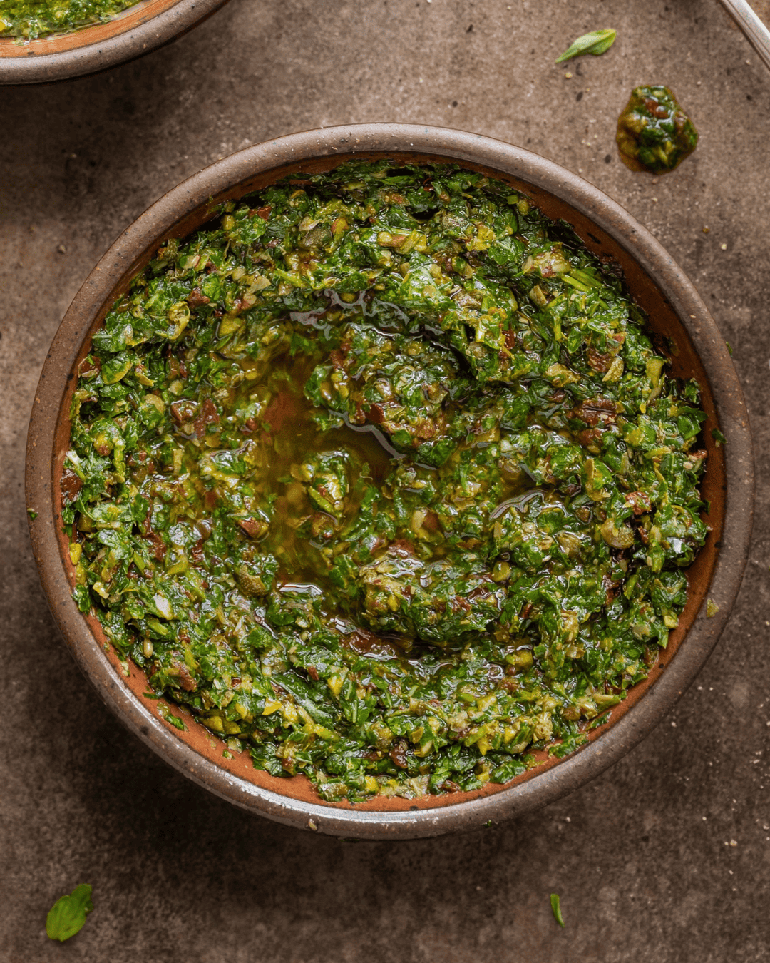 basil and parsley salsa verde in a bowl on a table.