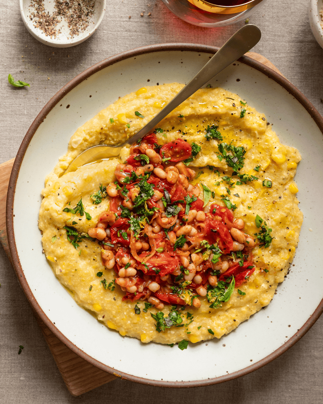 bowl of polenta topped with shallot tomato mixture.