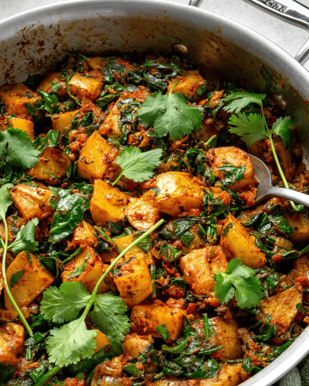 saag aloo in deep saute pan.