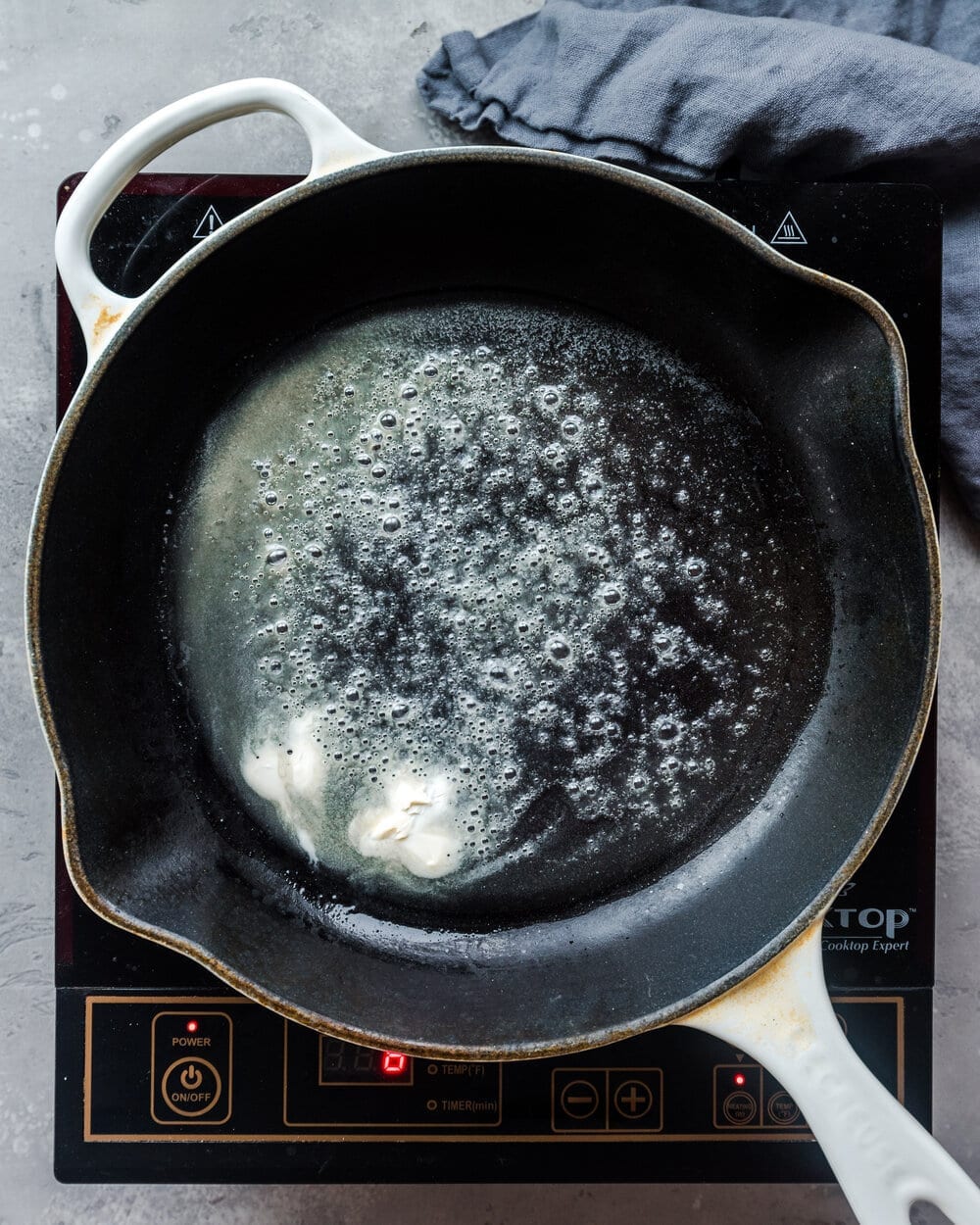 Butter melted in a hot skillet.