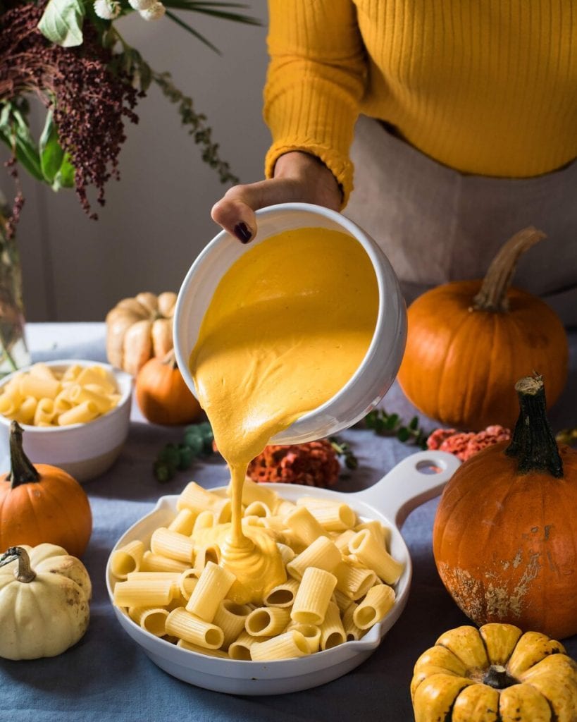 vegan mac and cheese sauce pouring over pasta