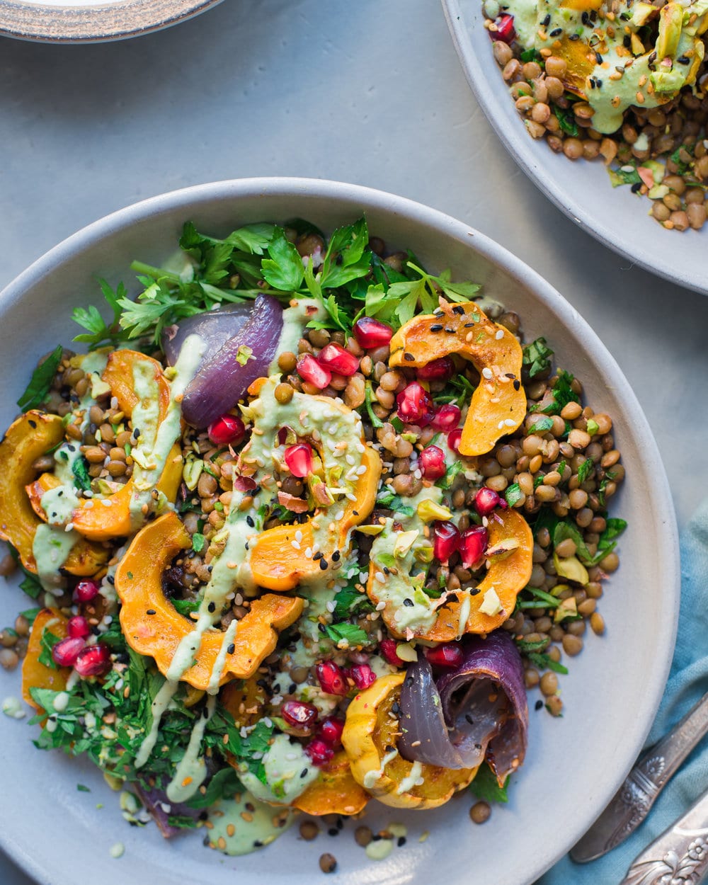 Large bowl filled with lentil salad on a grey table.