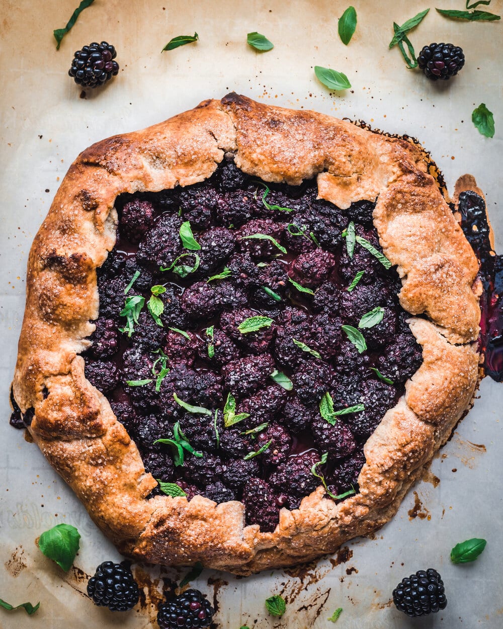 Cooked blackberry galette with mint and basil.