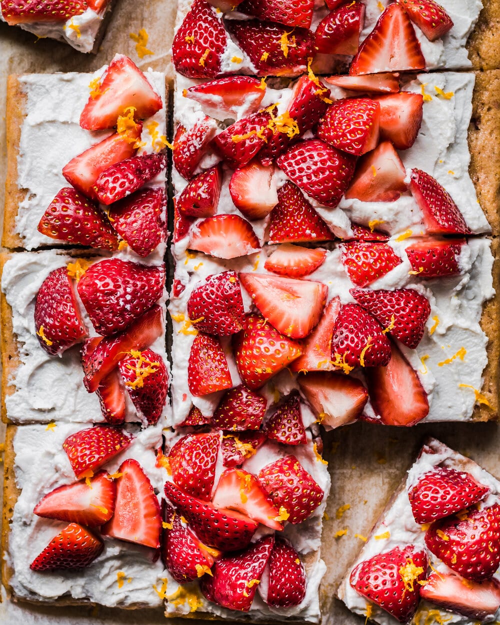 sliced strawberries and cream sheet cake.