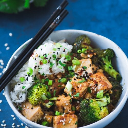 tofu and broccoli stir fry with white rice and chopsticks