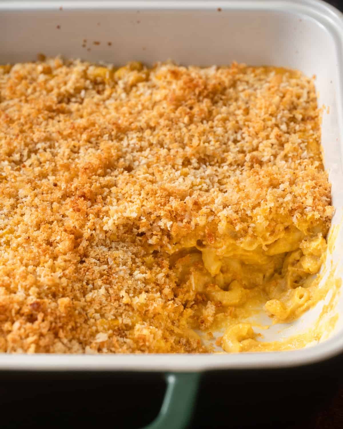 baked mac and cheese with crispy topping in a ceramic casserole pan.