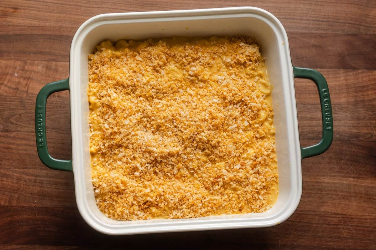 mac and cheese with buttered breadcrumb topping in a ceramic baking pan.