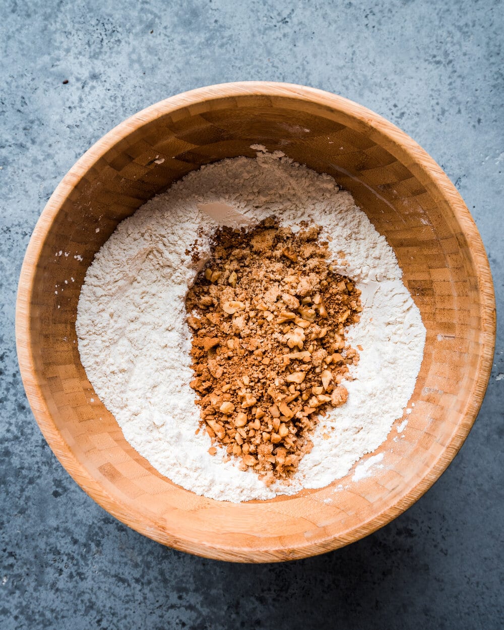 brown sugar and walnuts added to flour, baking powder, baking soda, and salt in bowl