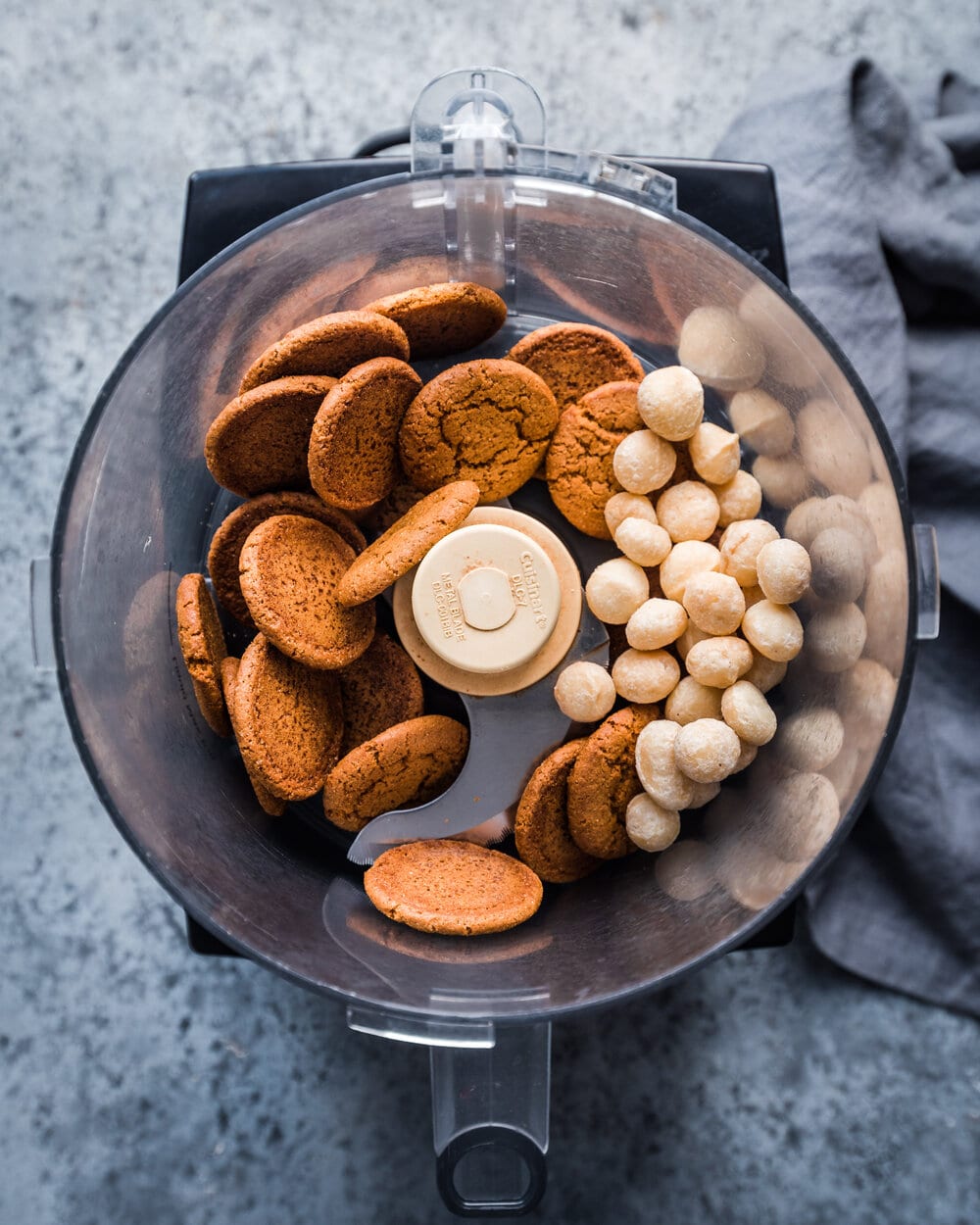 gingersnap cookies and macadamia nuts in food processor