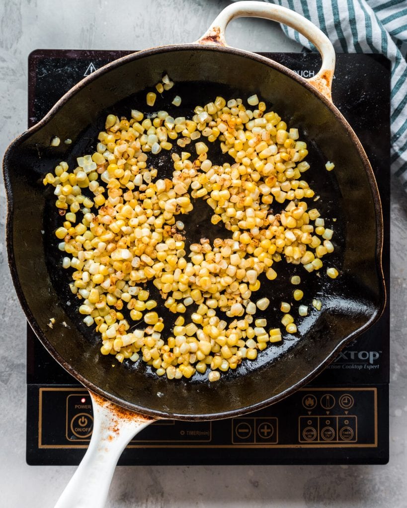 charred corn in a cast iron skillet
