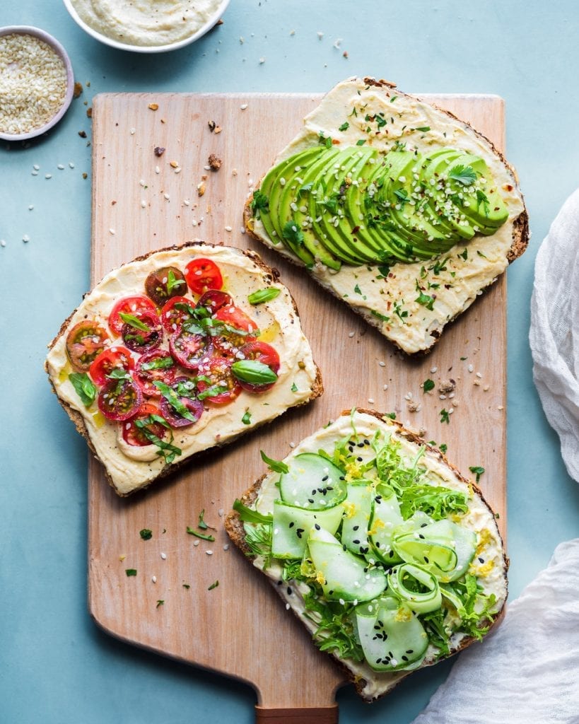 slices of toast with cheesy spread and veggies