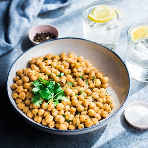bowl of marinated chickpeas with parsley and lemon