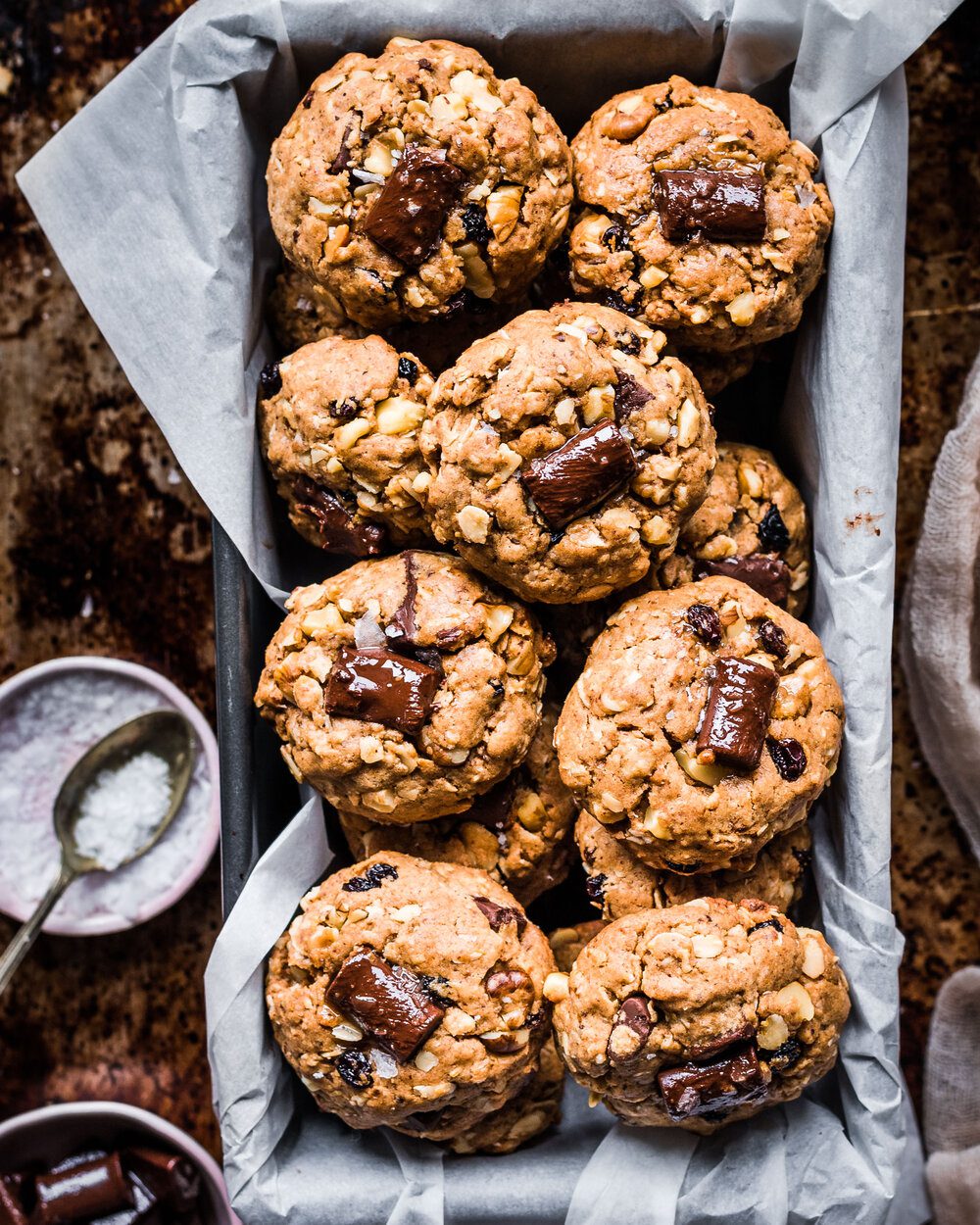 Loaf tin lined with parchment paper filled with cookies.