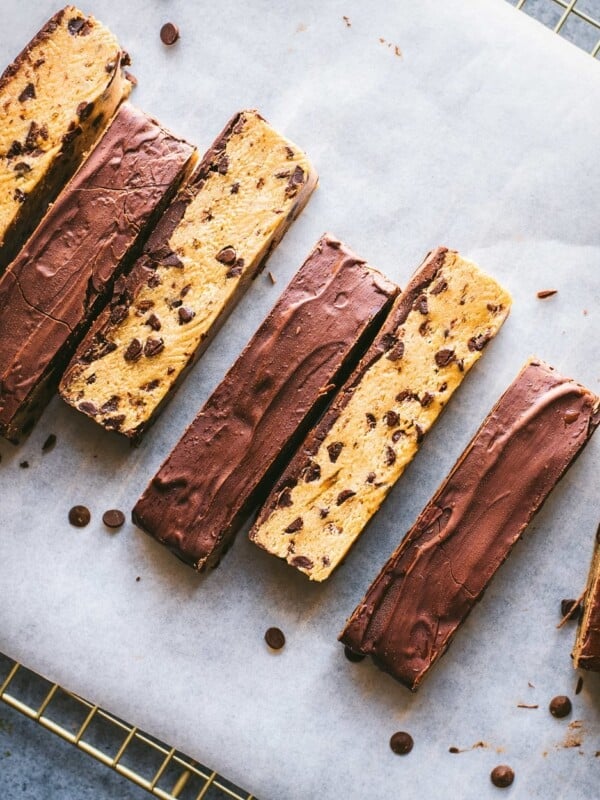 chocolate chip cookie dough bars arranged in a line on parchment paper