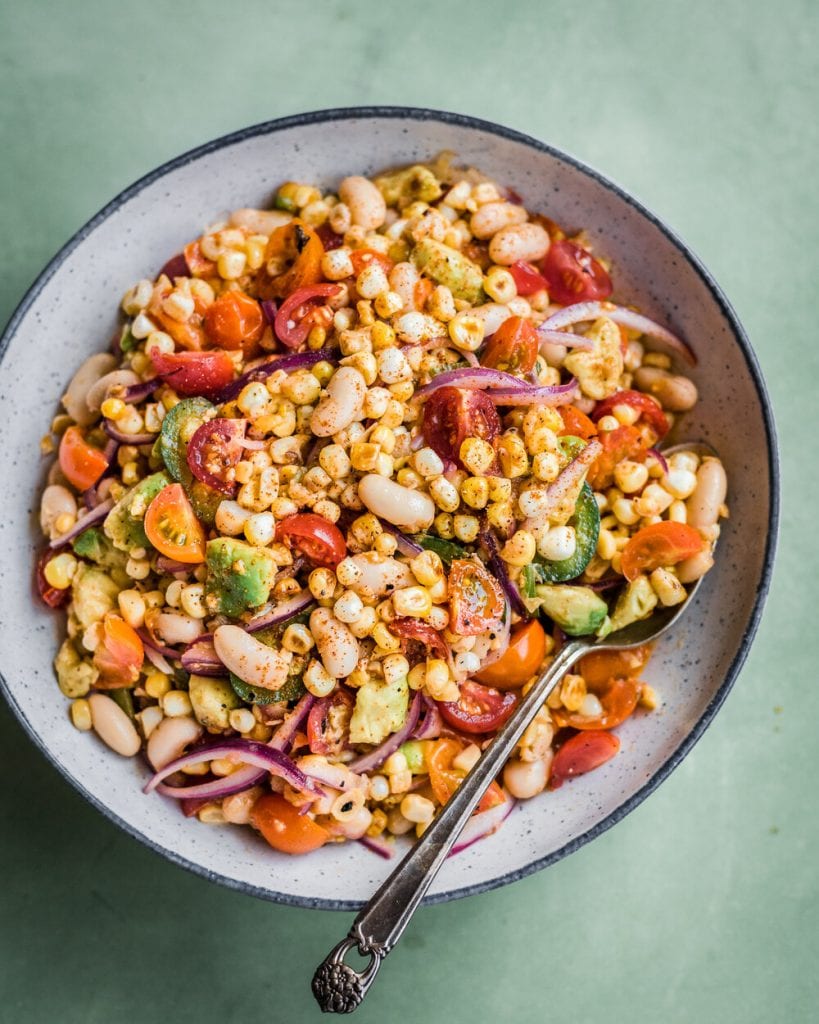 charred corn salad in a bowl with spoon overhead shot