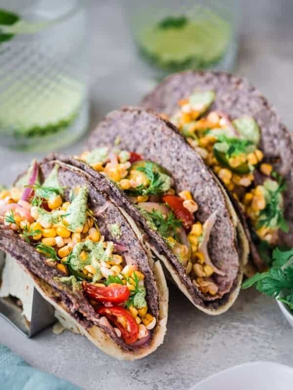 3 black bean and corn double wrapped tacos in taco holders