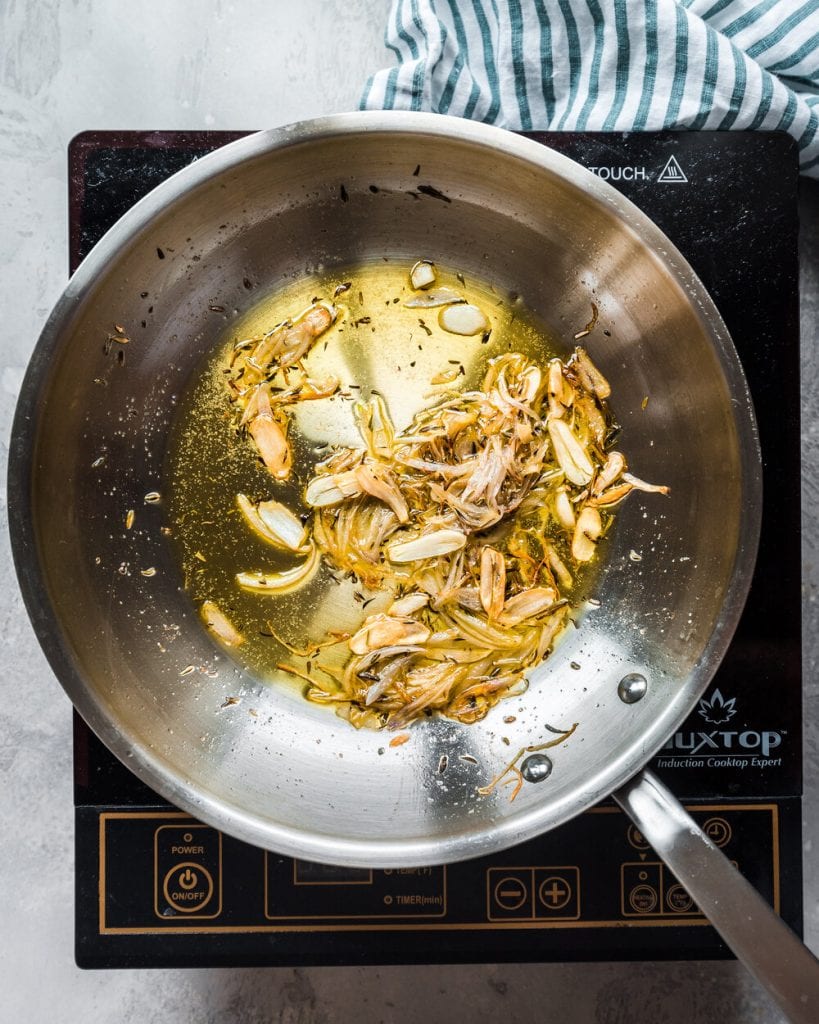 shallots and garlic frying in skillet