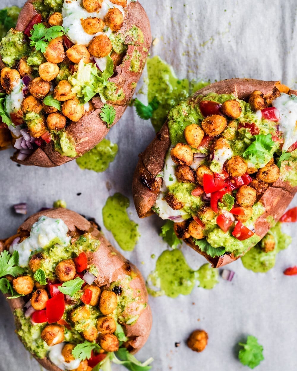 three stuffed sweet potatoes with tandoori chickpeas