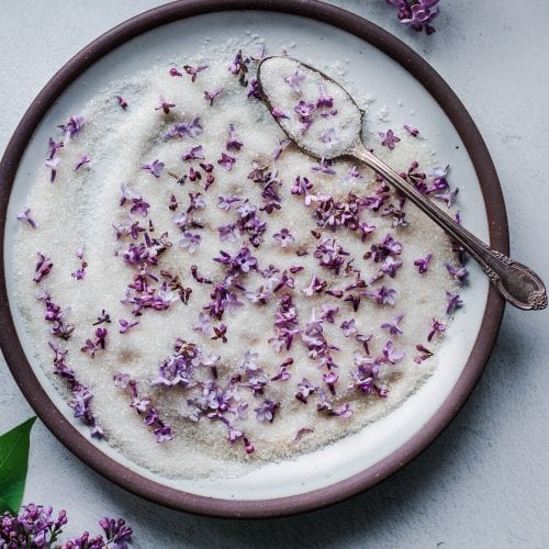 lilac sugar in a brown-rimmed bowl on a table