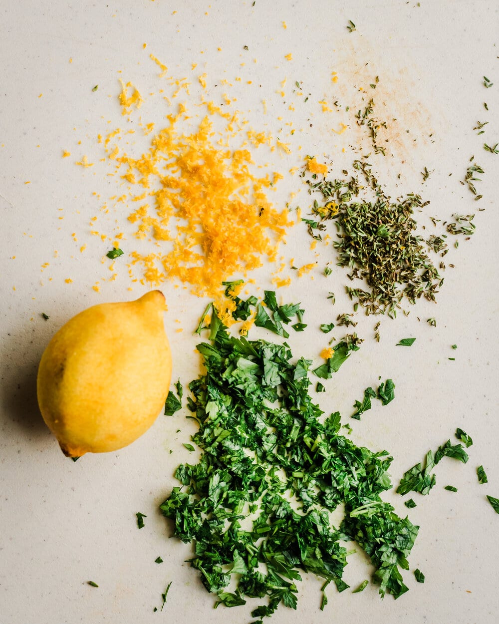 making gremolata with lemon zest, chopped parsley, and thyme. 