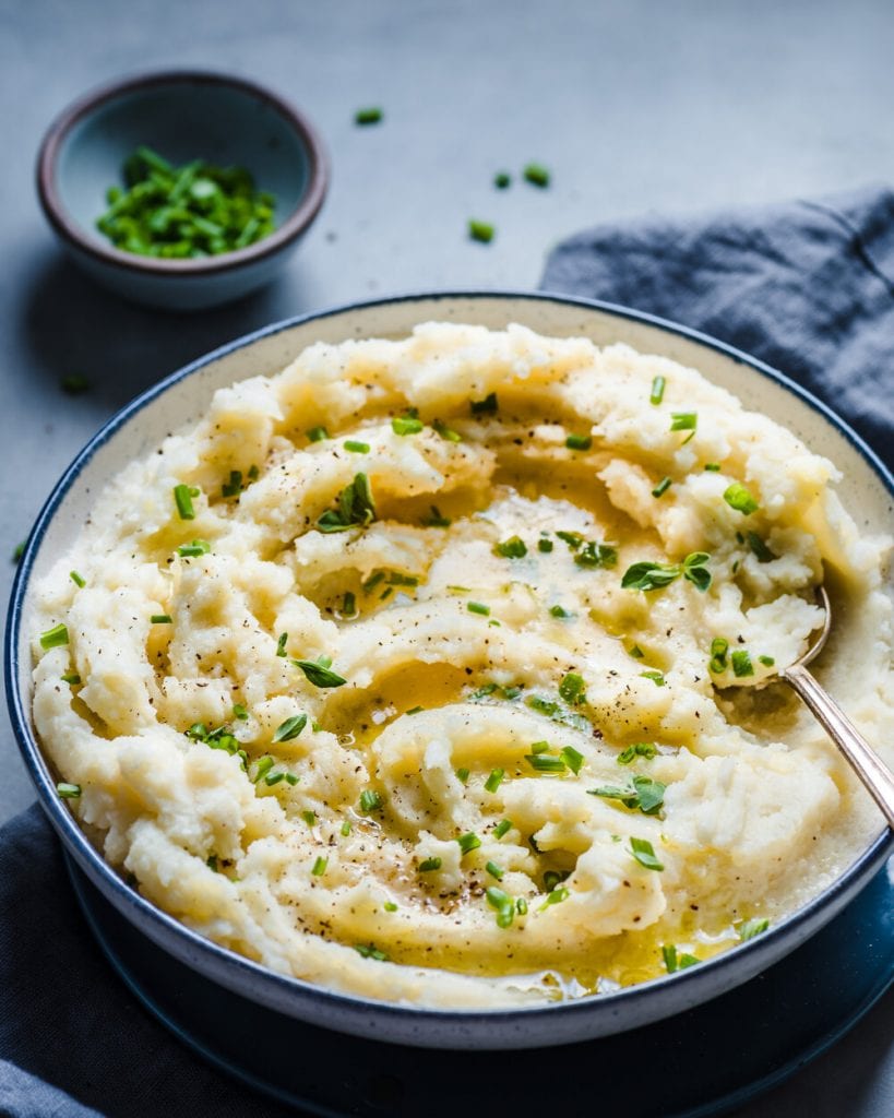 vegan mashed potatoes in a bowl with chives on top