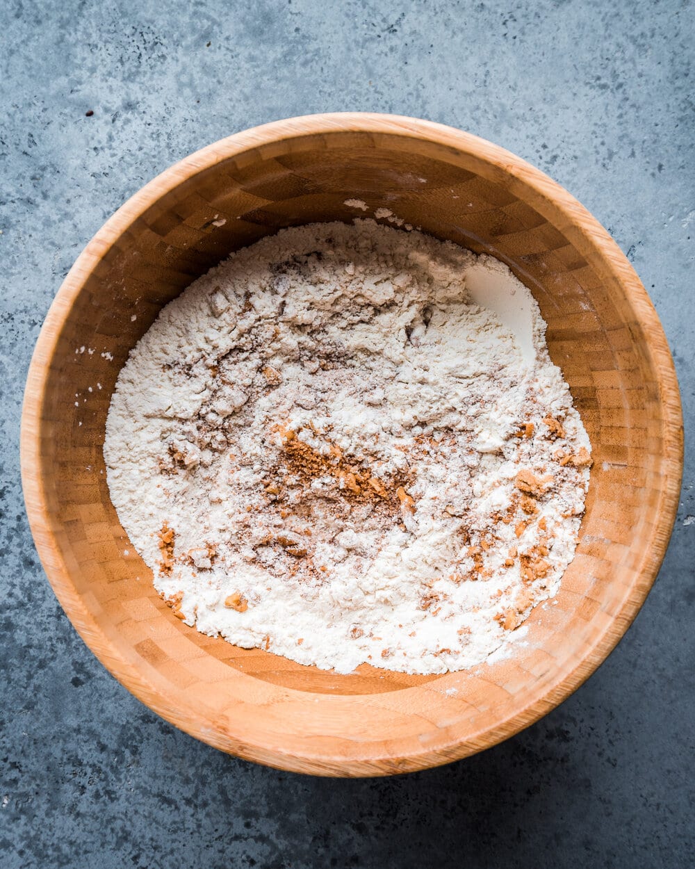 brown sugar and walnuts mixed with flour, baking powder, baking soda, and salt in bowl