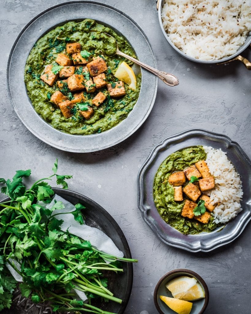 baked tofu palak paneer in a bowl with rice and other fixings