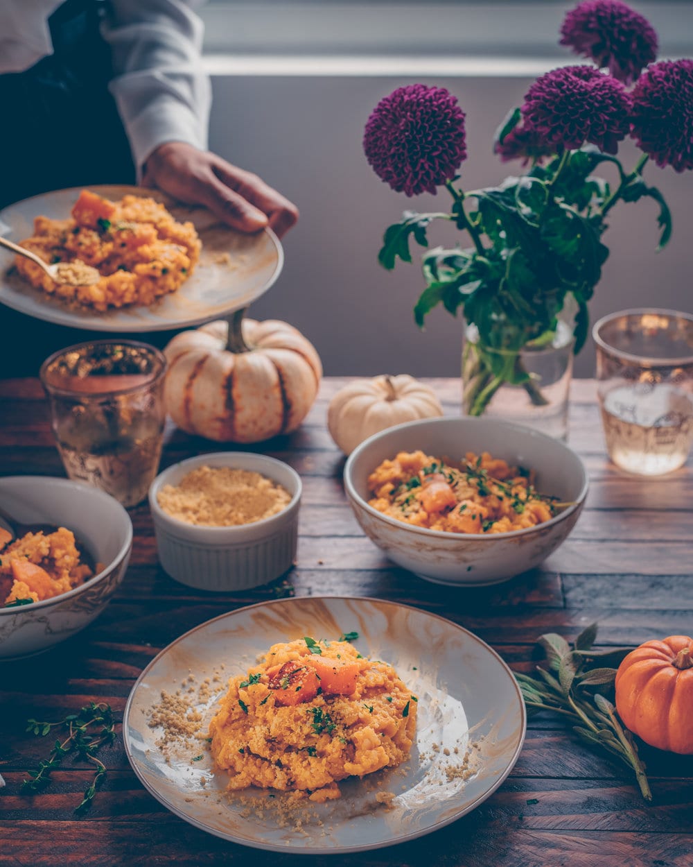 a dinner spread featuring butternut squash risotto.