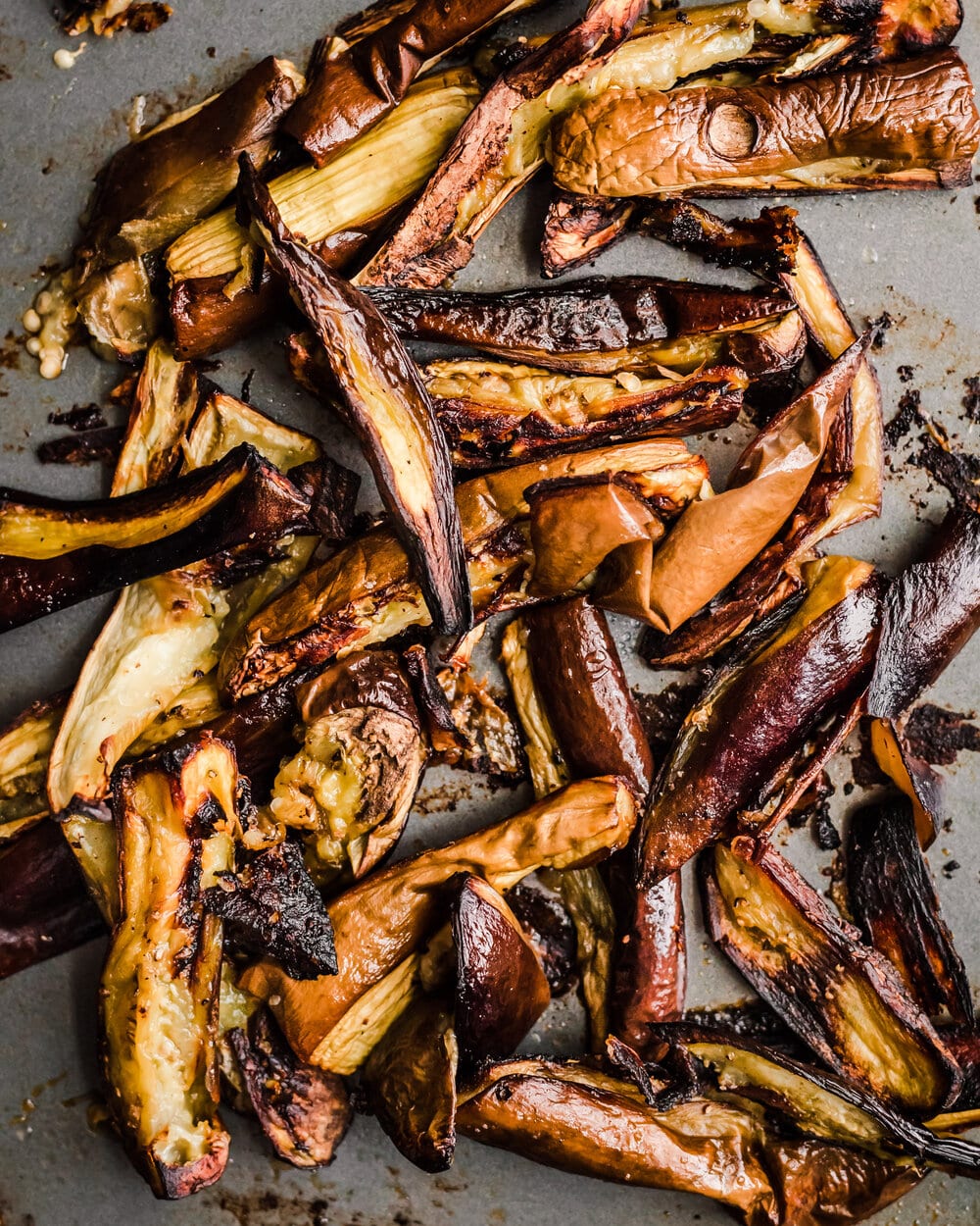 roasted eggplant on a baking sheet. eggplant food photography.