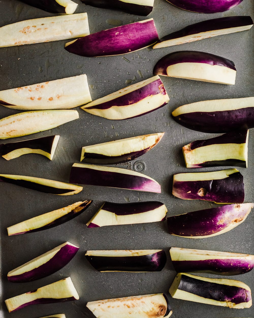 eggplant wedges on a sheet pan. 