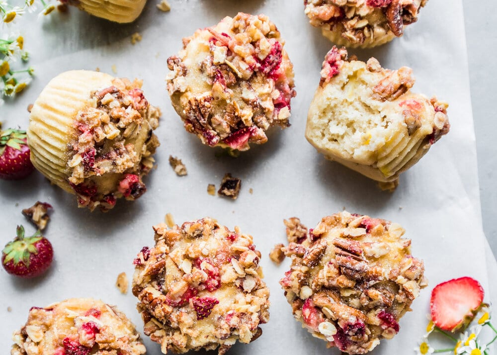 Overhead photo of finished muffins on a sheet of parchment paper.